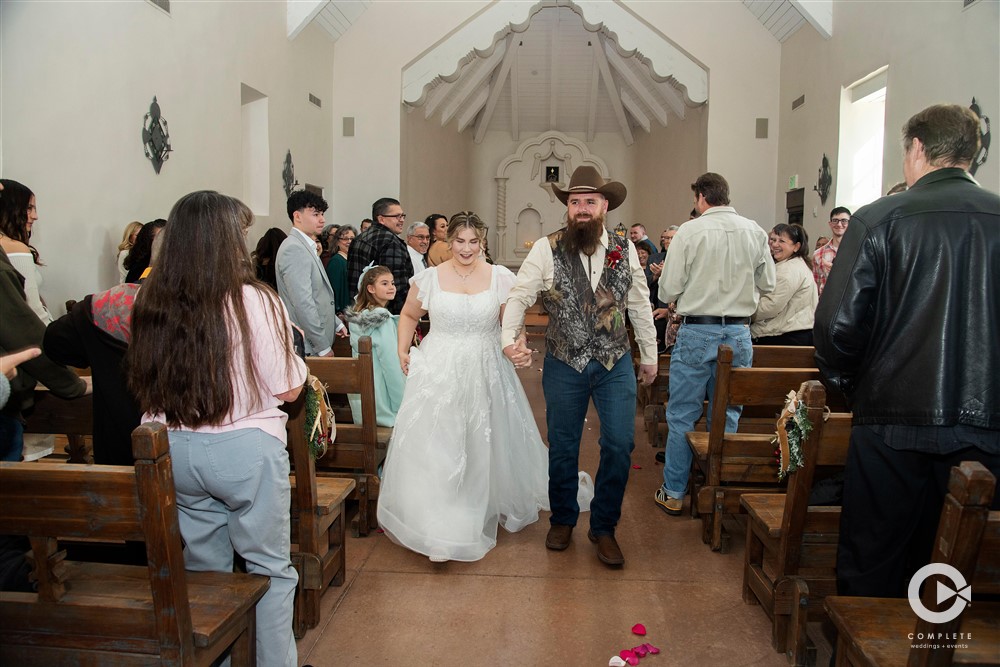 wedding photography couple exits chapel Old Town Albuquerque