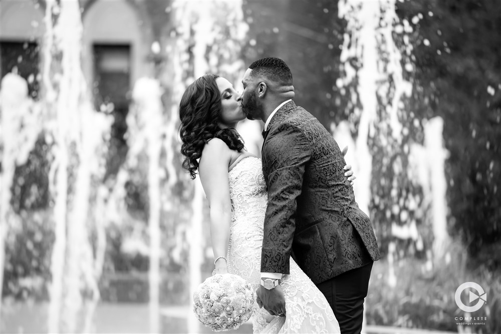 wedding kiss in front of fountain