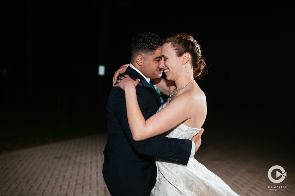 Outdoor wedding in the summertime Minnesota couple dances together