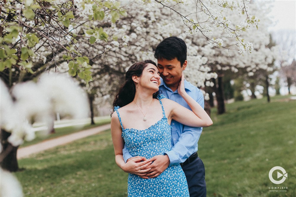 Engaged couple with an amazing wedding photo, awesome photo opportunity with blooming tree