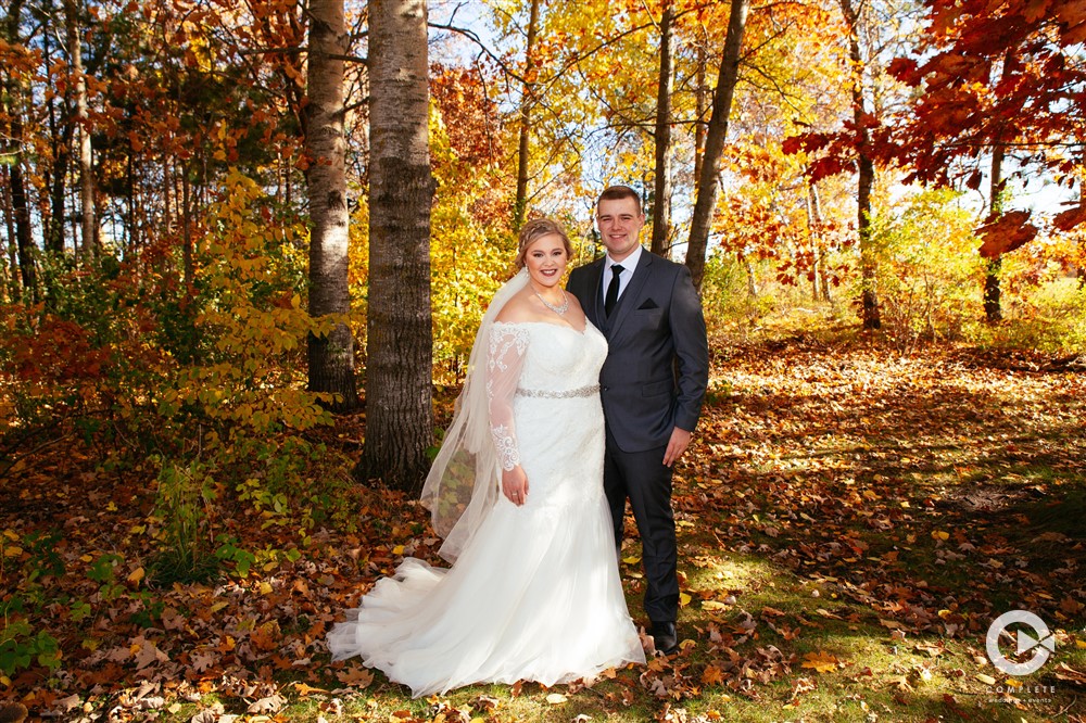 Couple smiling in outdoor fall wedding phoots
