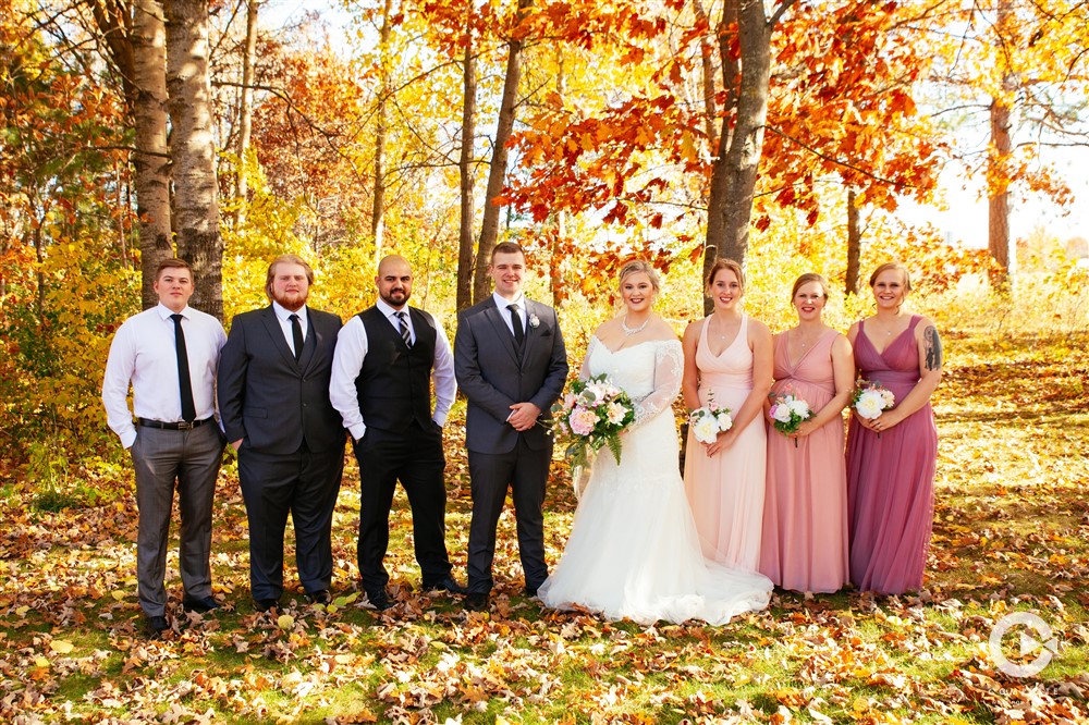 Outdoor wedding party photo in fall in Brained, MN