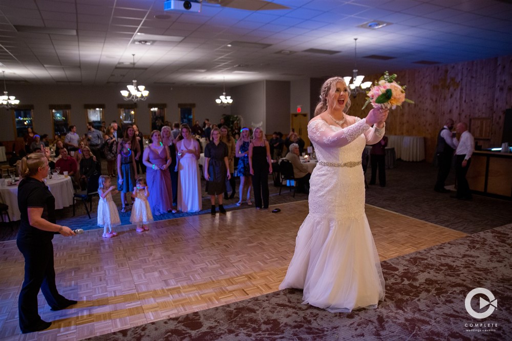 Bride doing bouquet toss