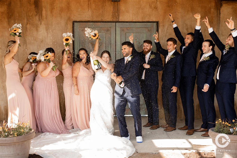 pop champagne wedding party photo