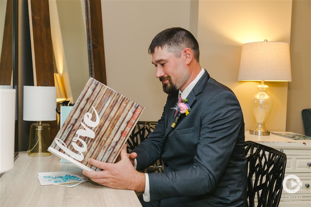 Groom reading wedding gift