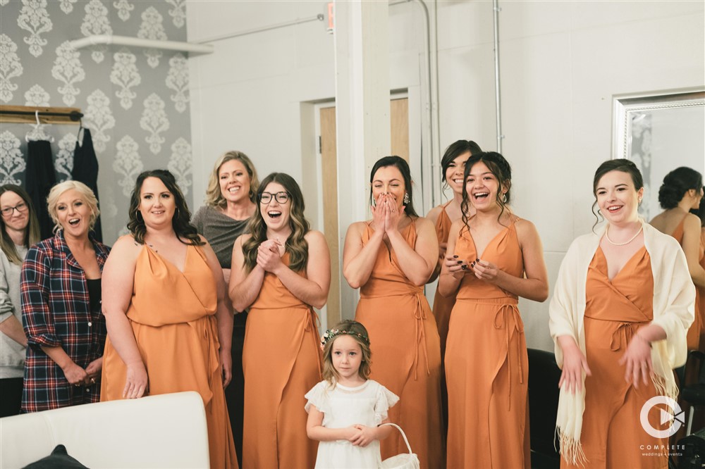 bride reveal for first look with bridesmaids