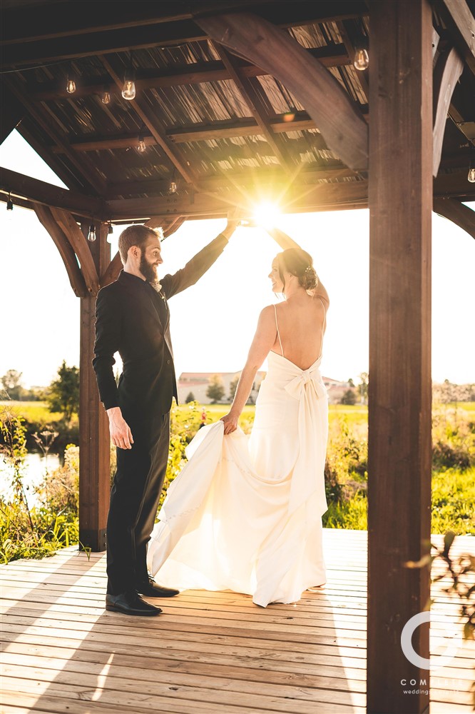 bride and groom dancing in sunlight