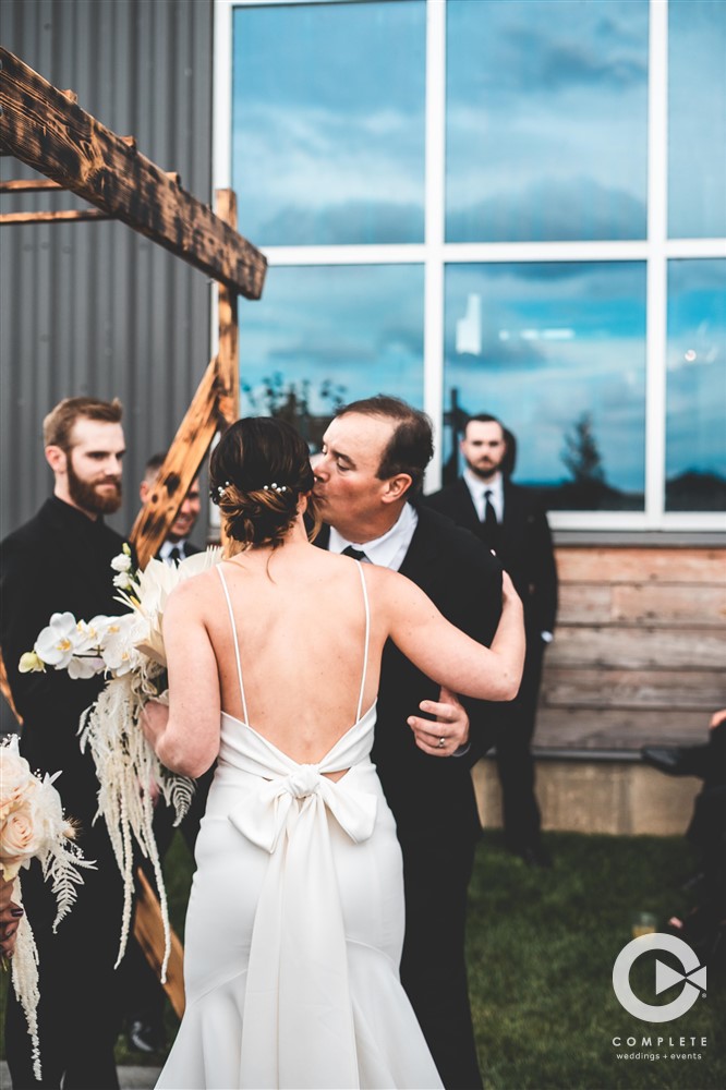 Father giving away bride at altar