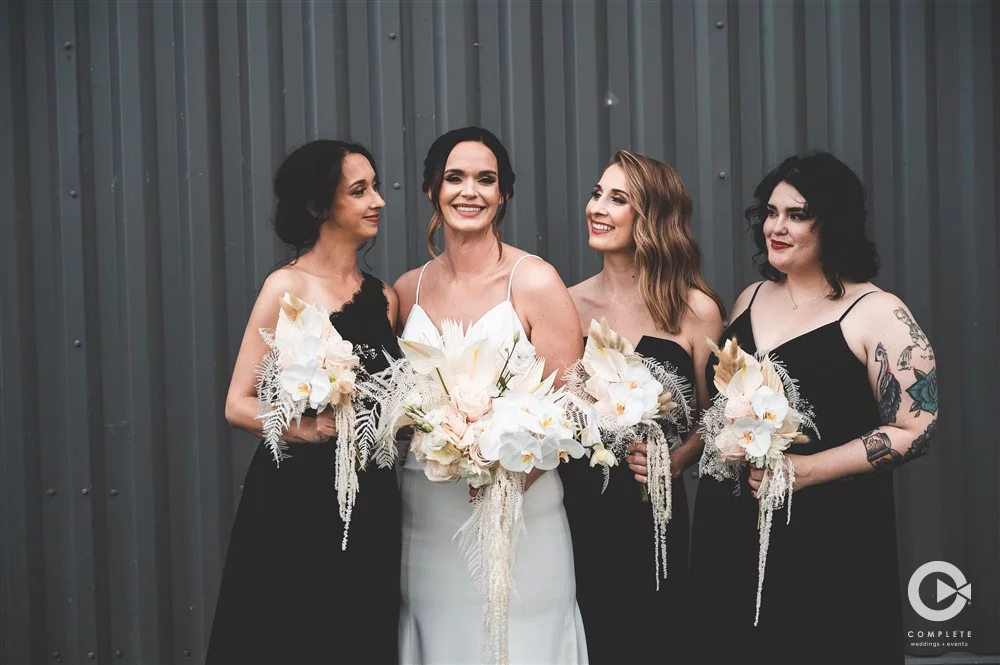 bridesmaids in black dresses with bride