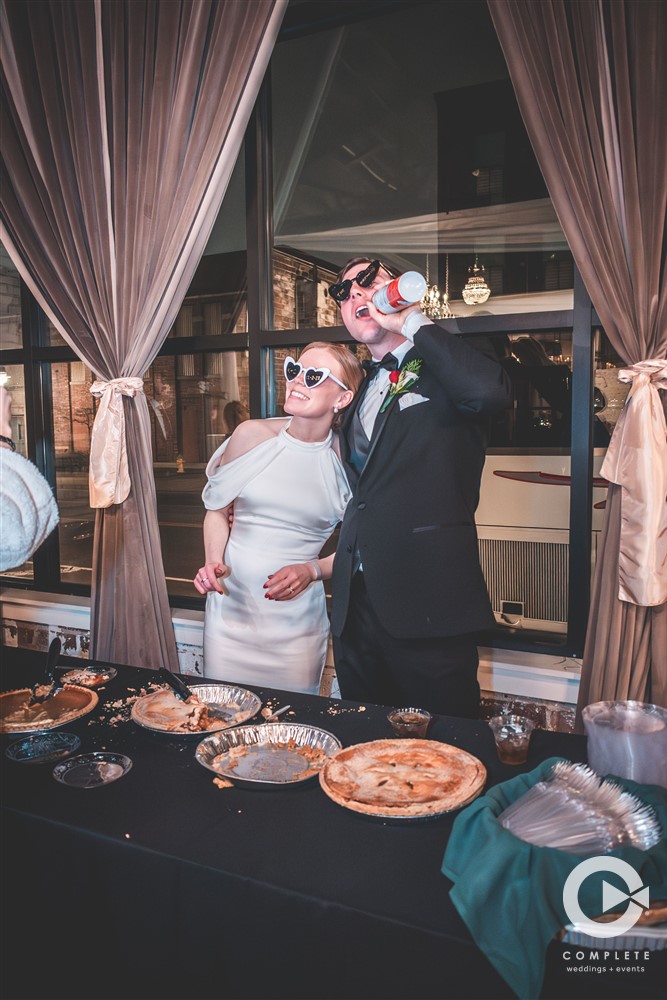 Complete Weddings + Events Photography, bride and groom cutting pie at their reception, wedding reception photos