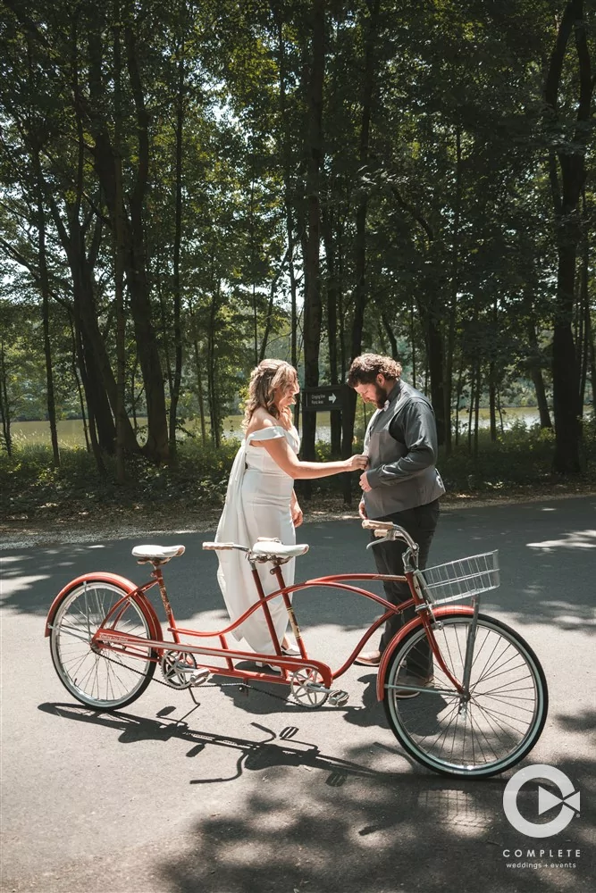 Complete Weddings + Events Photography, Weddings portraits, bride and groom riding a bike