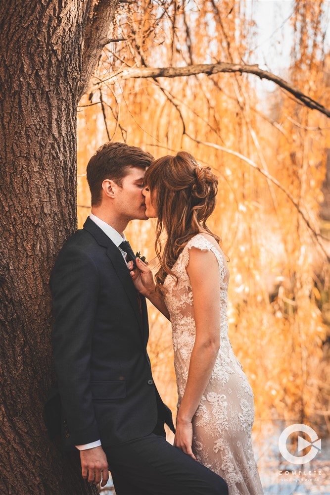 Complete Weddings + Events Photography, wedding portraits, bride and groom kissing at golden hour