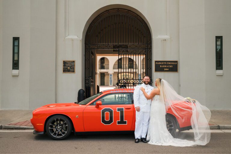 Bride and groom sharing a romantic wedding portrait beneath a historic stone archway in Charleston, South Carolina. Elegant Charleston wedding photography with timeless architecture and natural greenery.