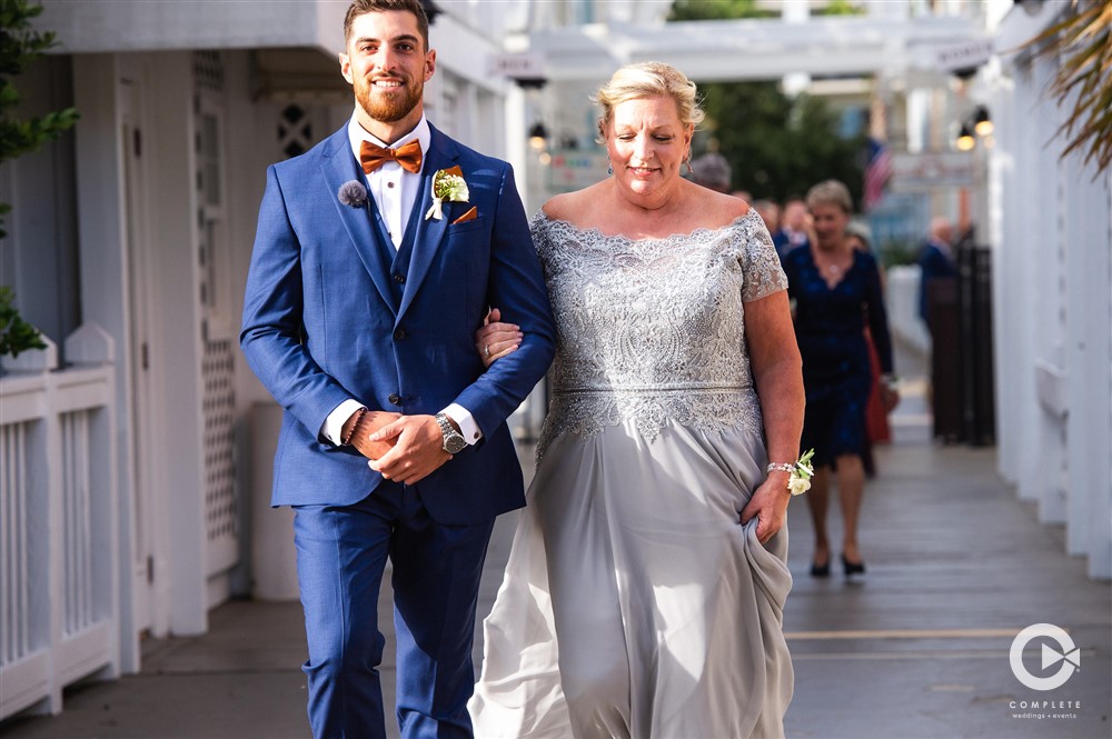 groom walking mother down the aisle