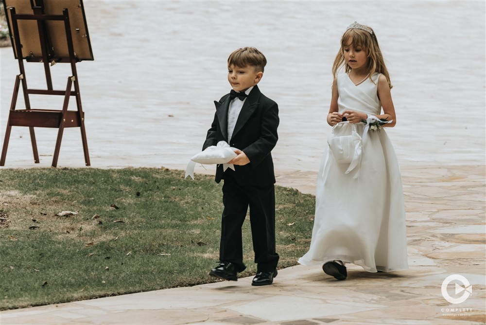 flower girl and ring bearer walking down the aisle