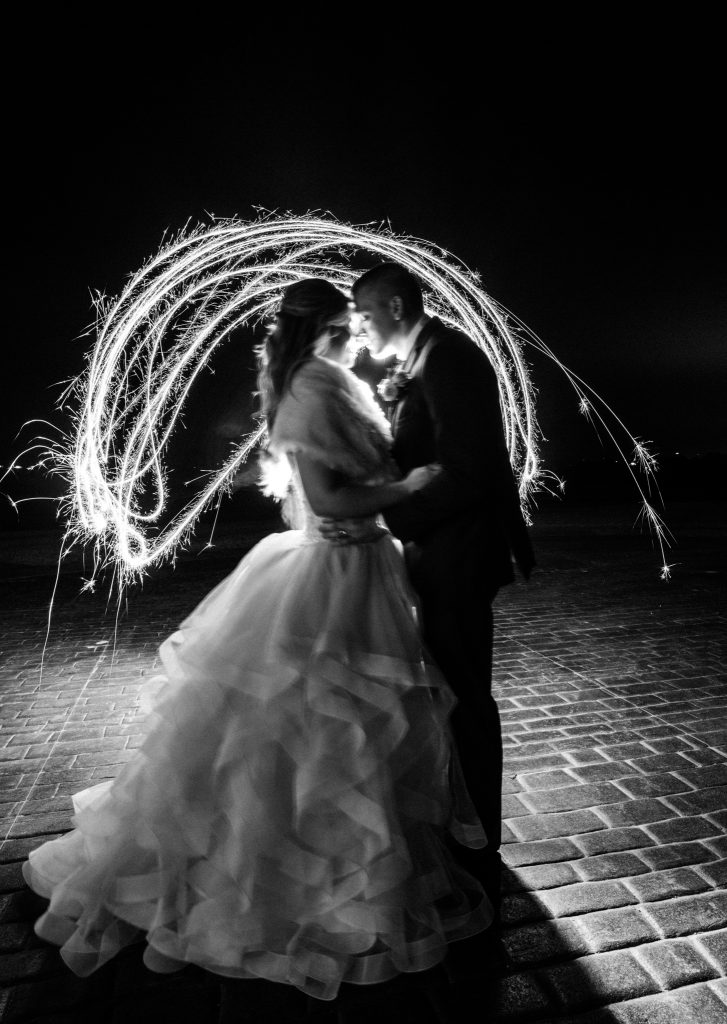 a nice artistic photo from a wedding with lights going over the bride and groom