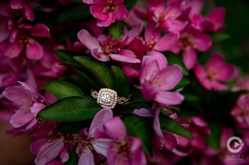 a wedding ring next to flowers