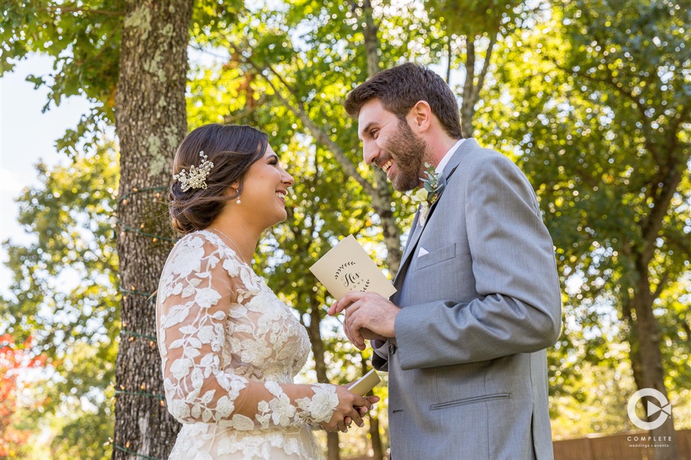 bride and groom read vows to each other