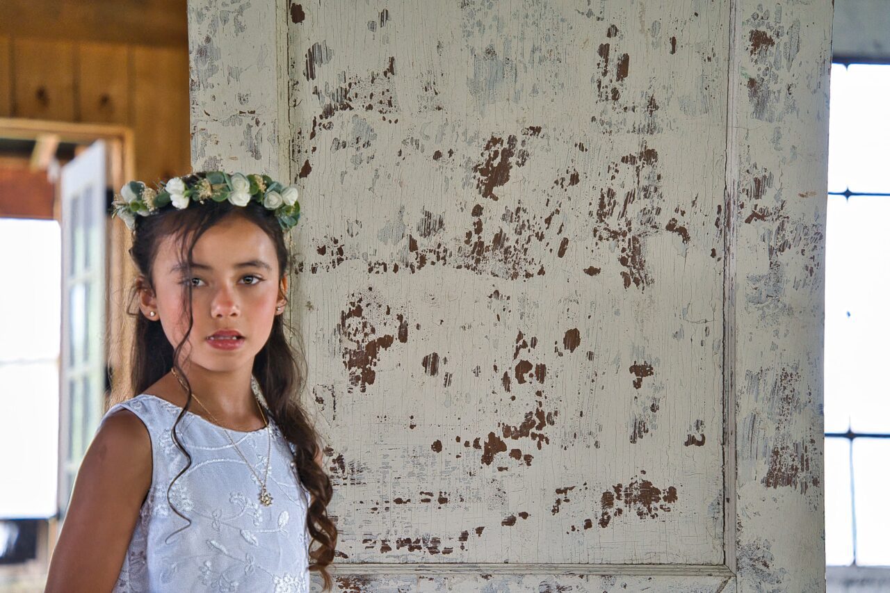 Flower girl posing for the photo. The photo was taken in Covington, Kentucky by wedding photographer Michael Evans of Complete Weddings + Events Cincinnati.