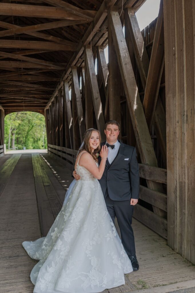 Bride and Groom pose inside a wooden bridge in Newport, Kentucky. Complete Weddings and Events photographer Michael Evans took this photo.
