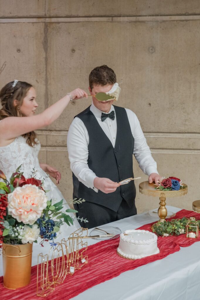 The Bride slam slice of cake into Grooms face.