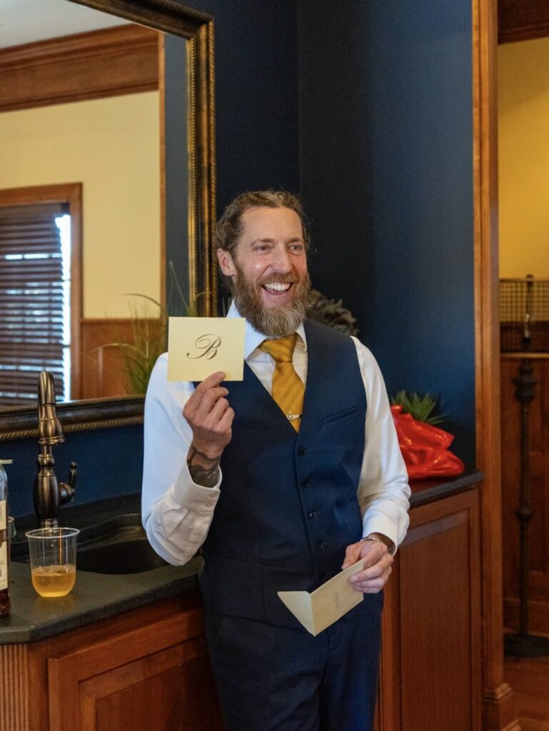 Bride gives Groom a pre-ceremony card. This photograph was taken in Kentucky by event photographer Michael Evans of Complete Weddings + Events Cincinnati.