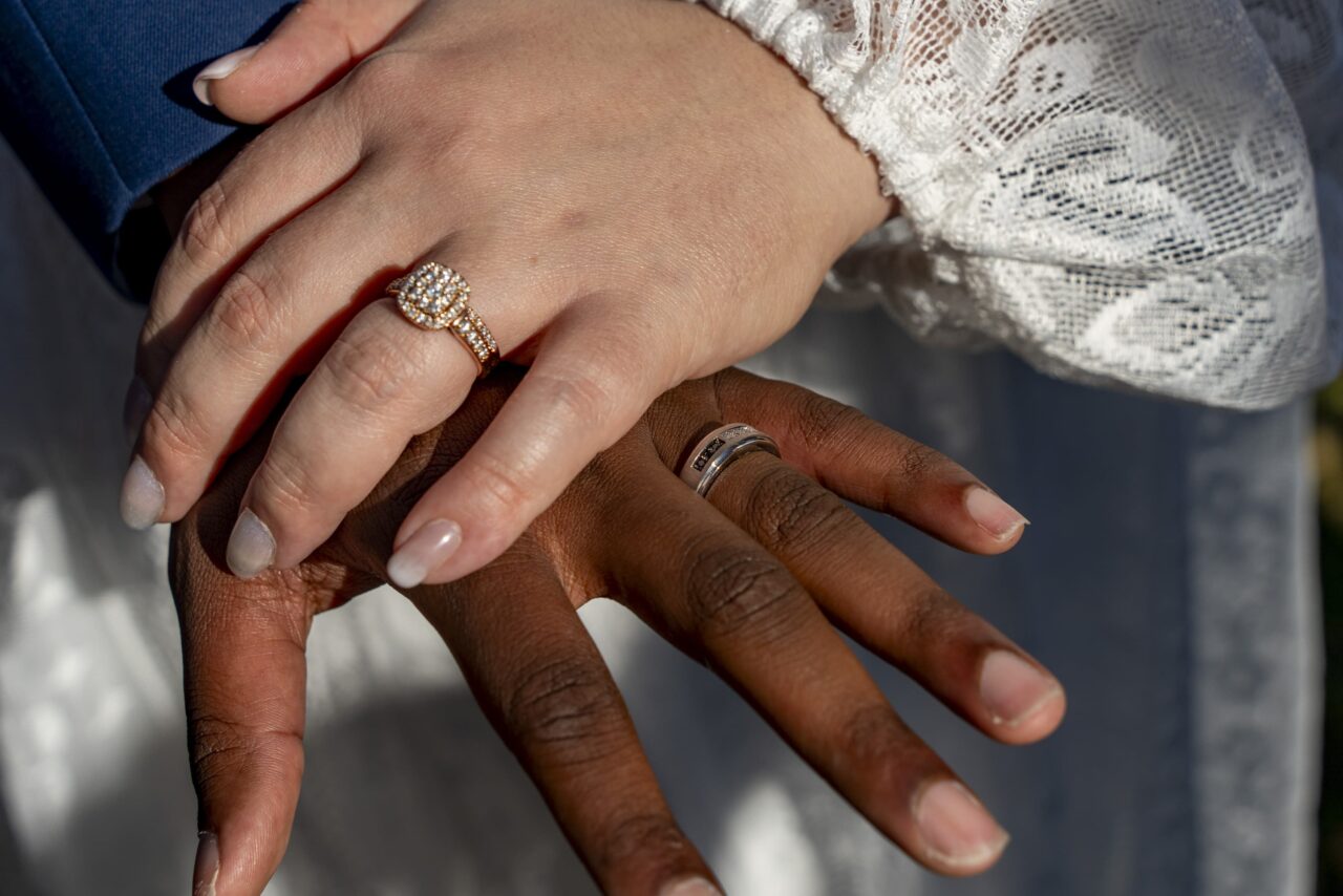 Bride and Groom put hands together to show their wedding rings. Photo was take near Dayton by Michael Evans of Complete Weddings and Events Cincinnati.