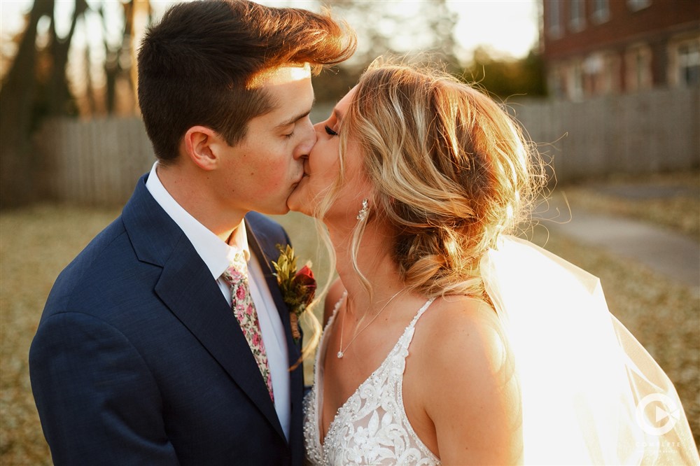 Biggest Wedding Regrets Couples Have Bride and groom kissing during late Fall wedding in Colorado