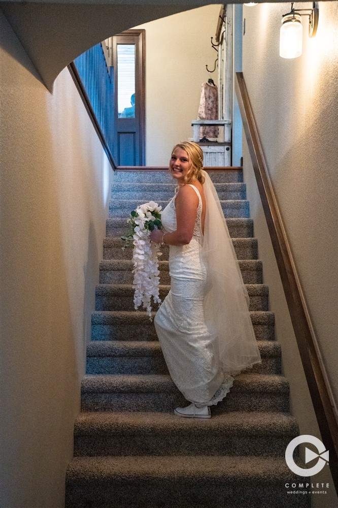 Bride walking up stairs Colorado wedding