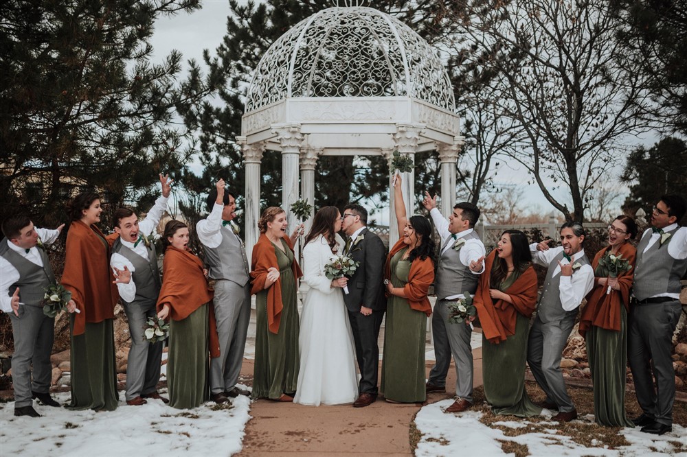 Bridal party celebrating marriage of bride and groom during a winter wedding in Colorado Springs