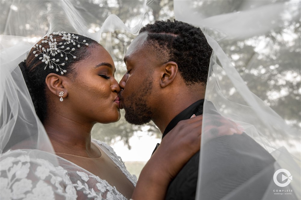 Bride and groom kissing on wedding day amazing shot of couple outdoors in Colorado