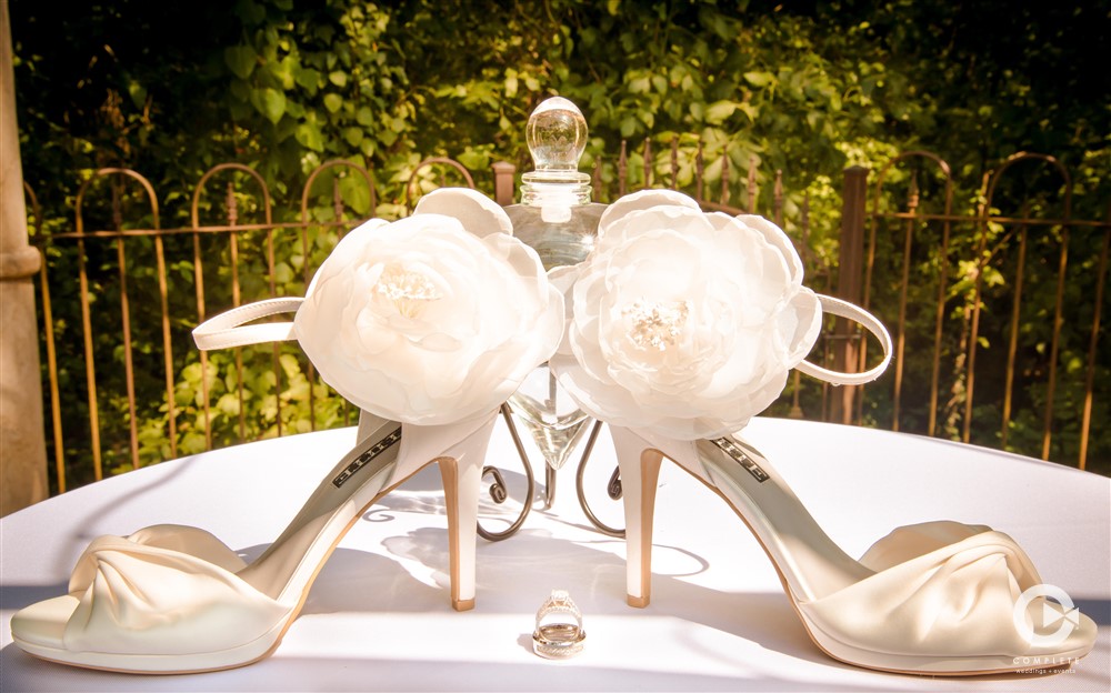 Detail photo of shoes with white flowers at the heels timeless wedding shot