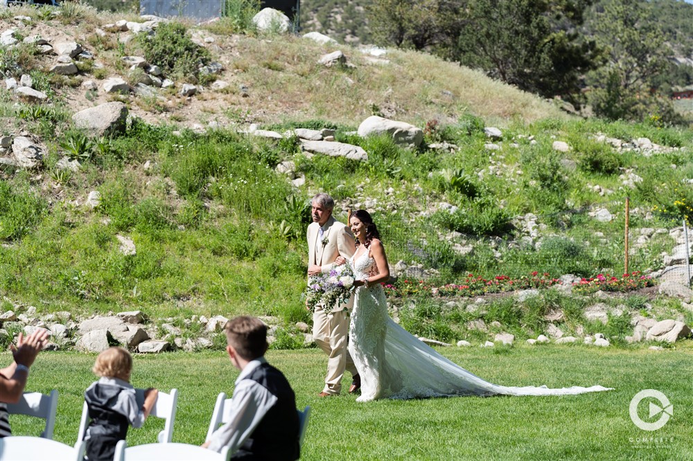 Bride being escorted by father during a Mount Princeton wedding ceremony