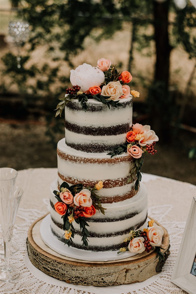 Wedding cake detail shot with flowers cascading down the beautiful wedding cake