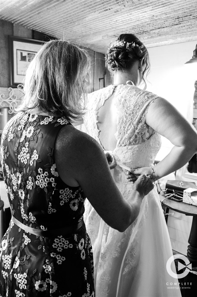 black and white image of bride getting ready with mom