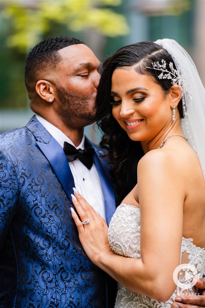 bride and groom in formal attire, blue tuxedo