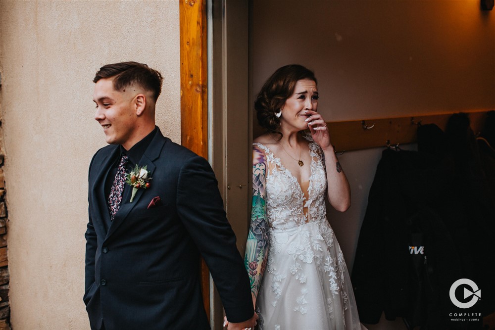 bride and groom first look in a doorway