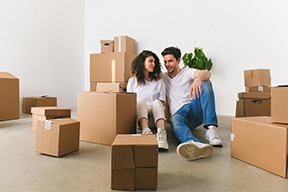 a young couple preparing boxes for storage