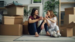 a couple sitting on the floor talking about their just married apartment problem
