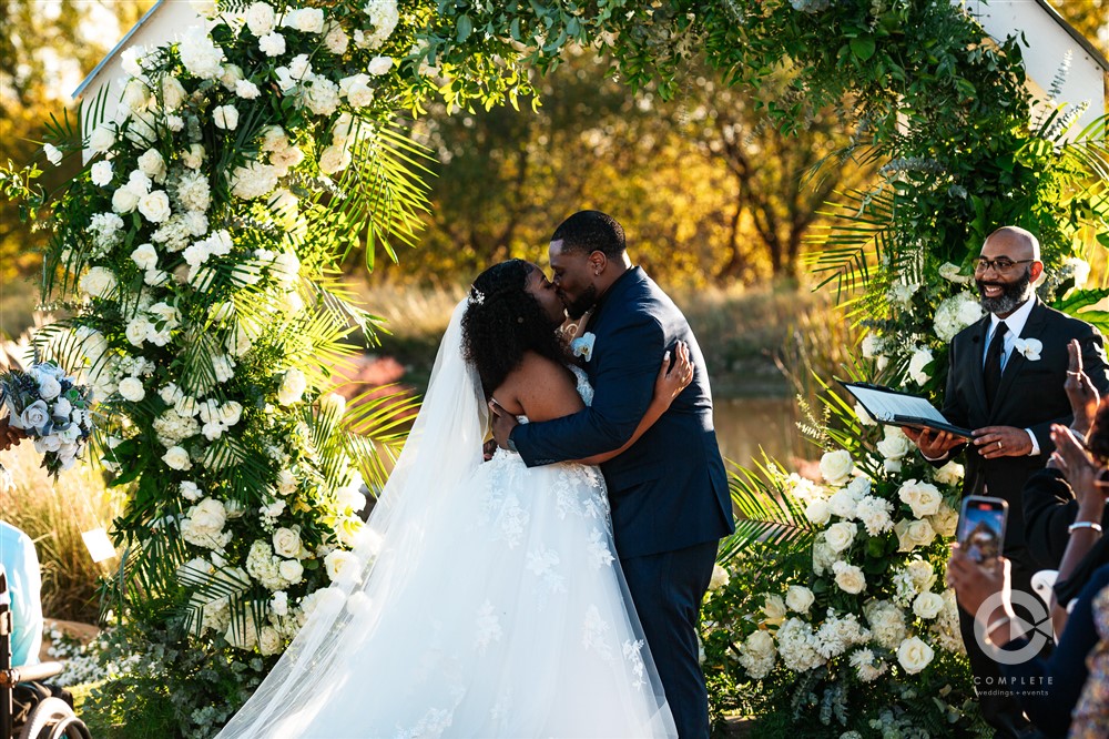 bride and groom under altar