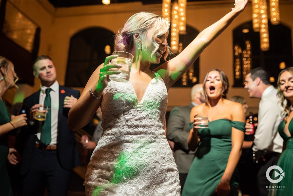 bride dancing on dance floor with drink