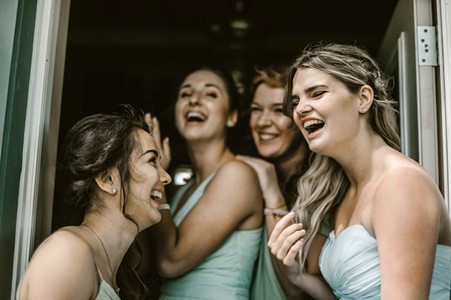 bridesmaids laughing after using a photo booth at your wedding