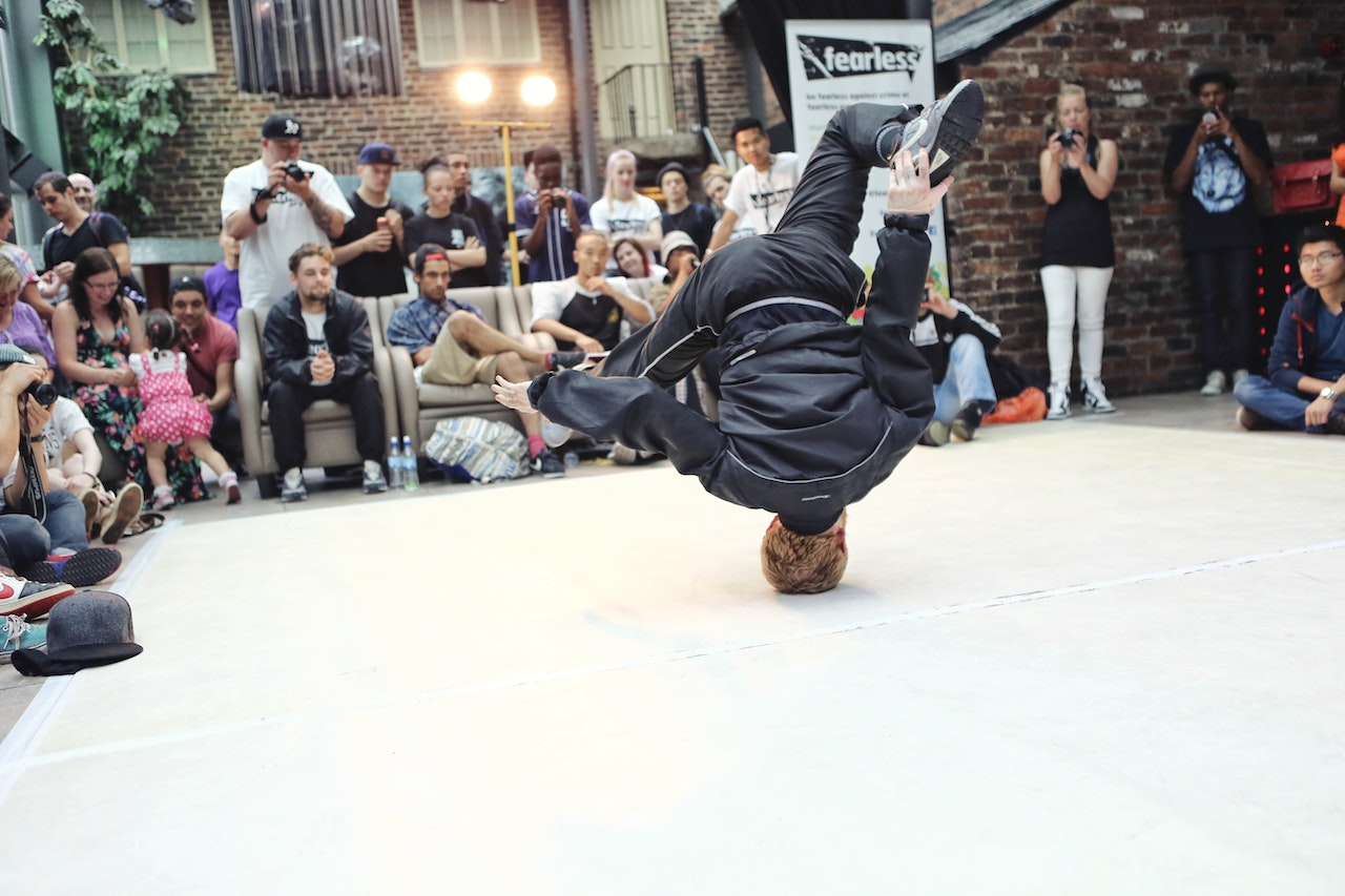 A man breaks dance on his head