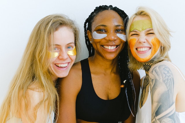 Three girls with cosmetic masks on their face