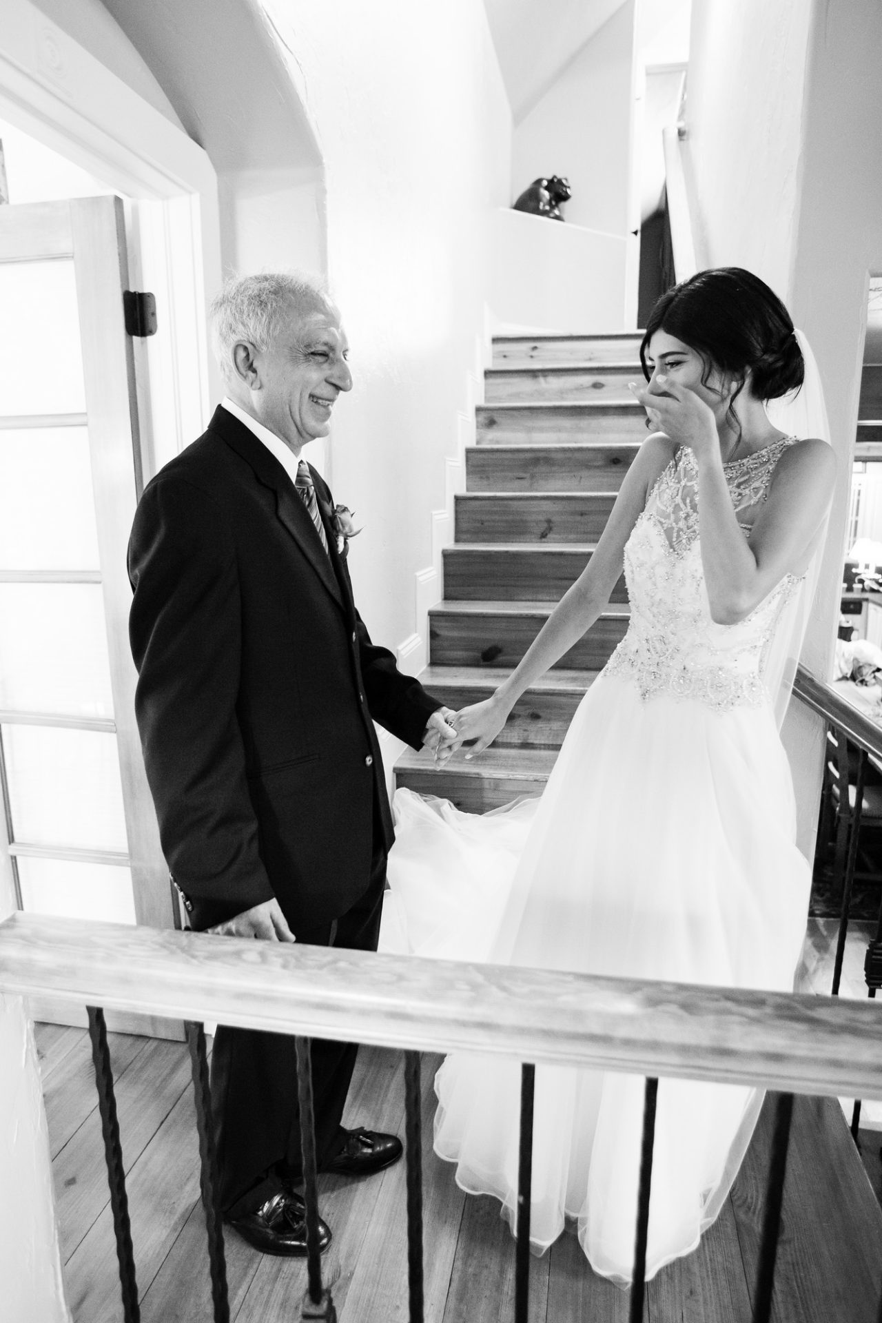Black and white picture of a grandpa seeing his granddaughter in her wedding dress for the first time