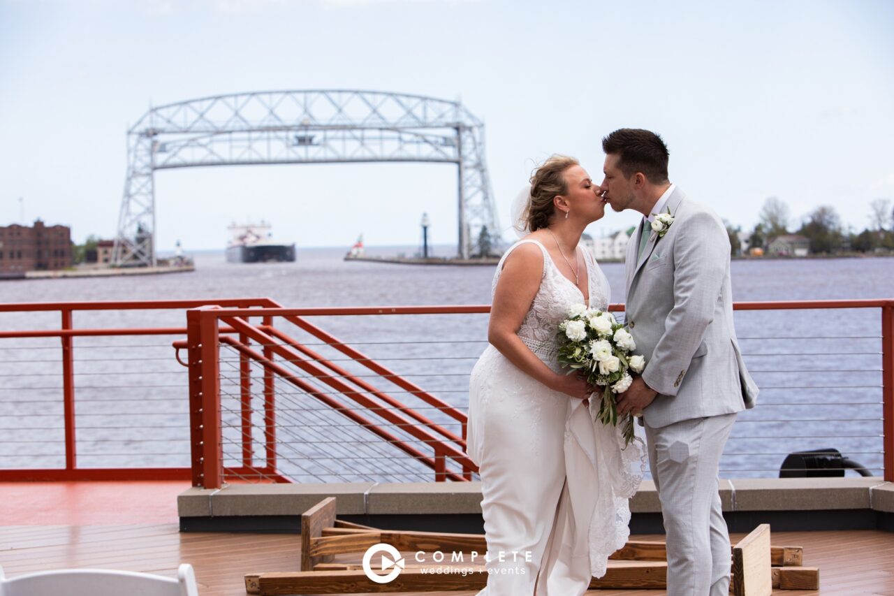 Couple having moment while at Pier B in front of the Aerial Lift Bridge.