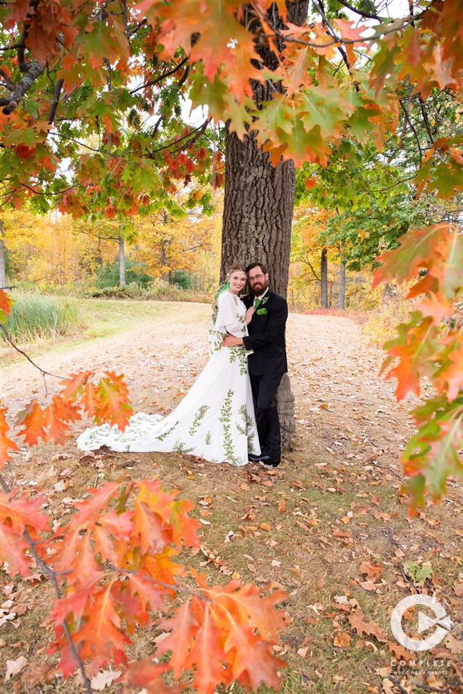 Gael and Alex stand under a tree as it shows its fall colors at Big Sandy Resort.