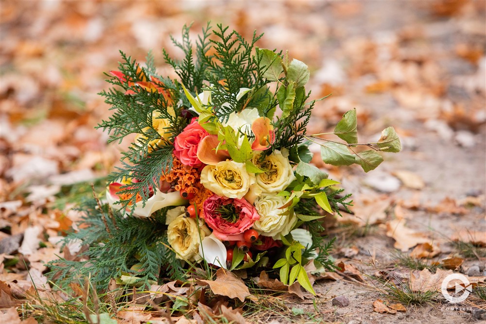 wedding bouquet, many colors set amidst the fall leaves