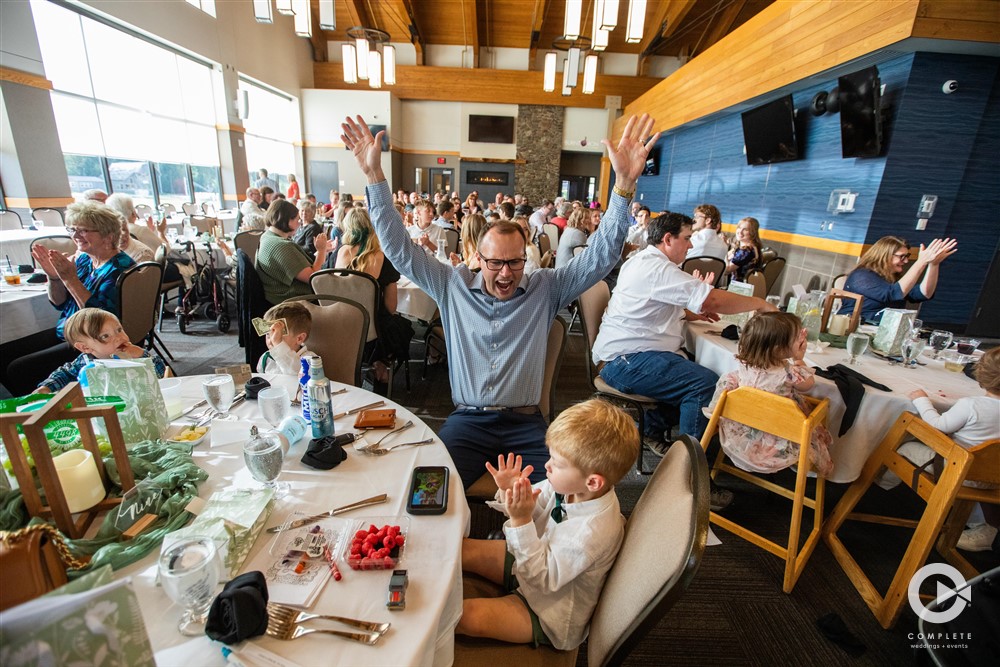 Picture of parents with kids playing games at table