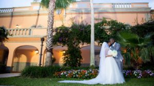 Bride and Groom kissing in front of The Signature Grand